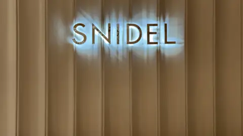 ตัวอักษร SNIDEL พร้อมแสงออกหลัง